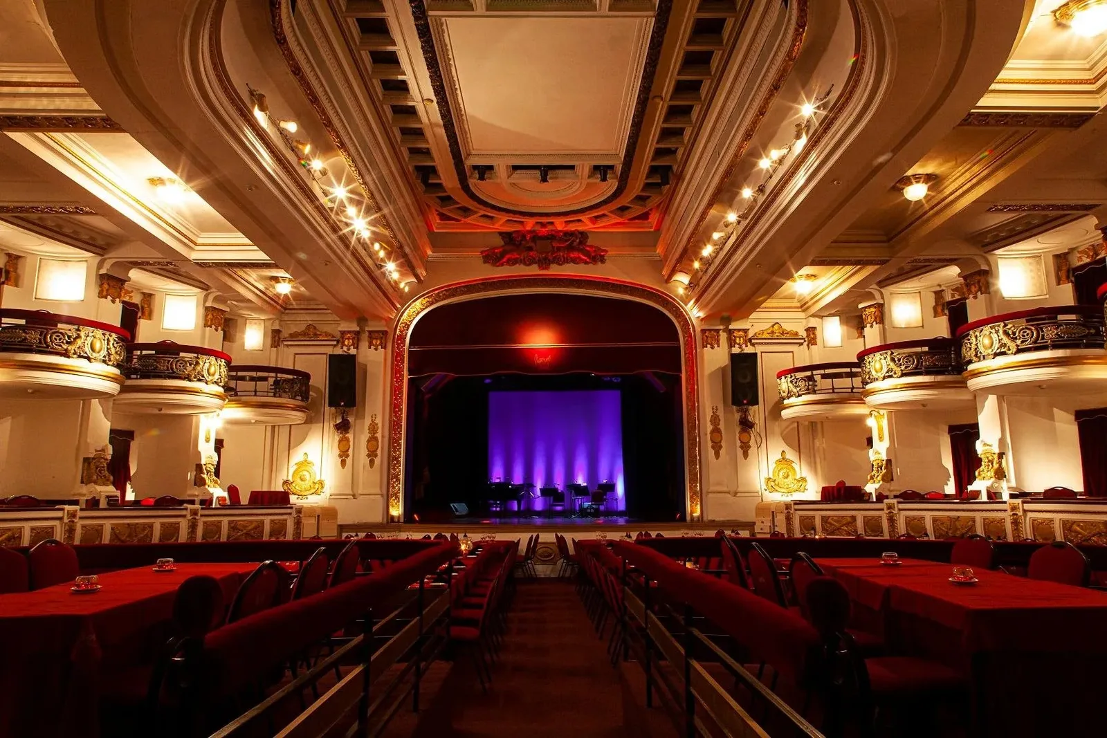 The banked red seating and gilded balconies of the Piazzolla Tango theatre in the Galeria Guemes