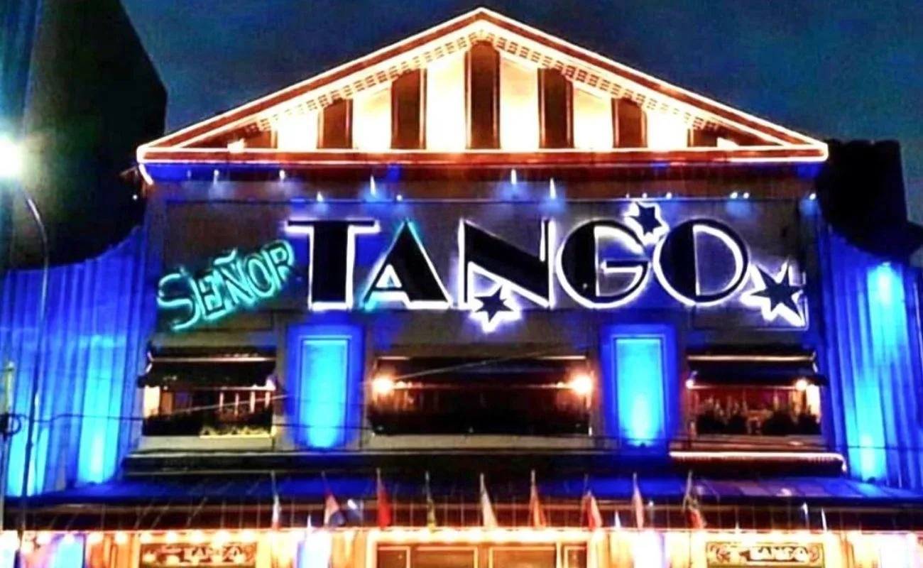The illuminated facade and neon sign of the Senor Tango venue in Barracas at night
